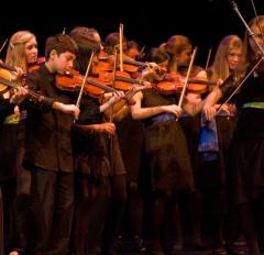 Group of people playing violin
