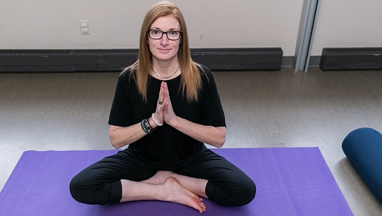 Toni practicing yoga on a purple mat