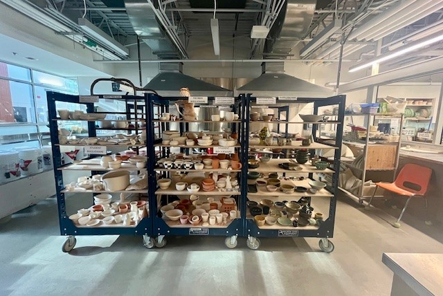Interior of the pottery studio at the Delbrook Community Recreation Centre, showing bisqueware shelves.