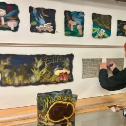 NVRC resident artist Isabelle Kirouac stands next to the completed Felting the Mycelial Web community art project. 