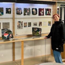 NVRC resident artist Isabelle Kirouac stands next to the completed Felting the Mycelial Web community art project. 