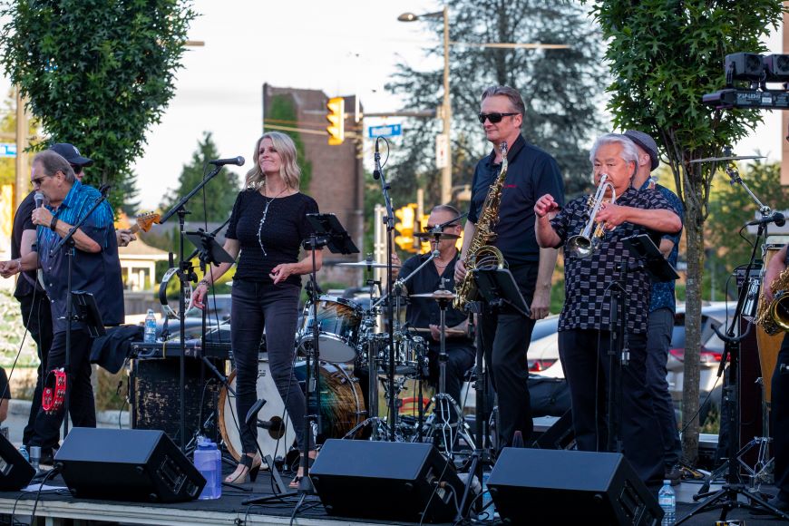 A band performs on a stage in Seylynn Park. 