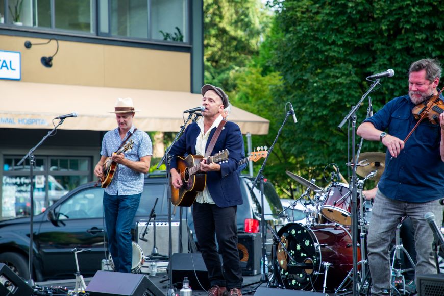 A band plays on a stage in Edgemont Village. 