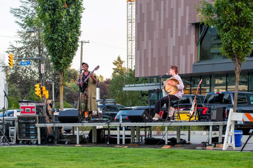 A band performs on a stage in Seylynn Park. 
