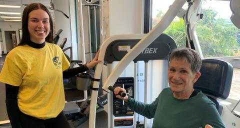 Volunteer assists in fitness centre