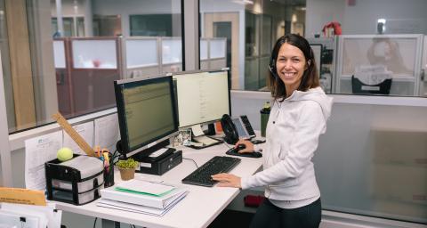 Call centre staff member smiling at camera