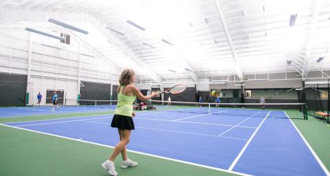 A woman plays tennis at the North Vancouver Tennis Centre.