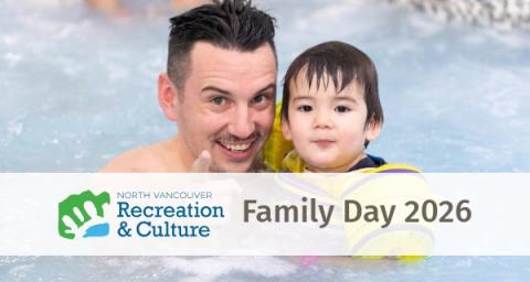 A man and baby smile at the camera while swimming in a pool. 