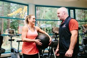 Personal trainer advising trainee