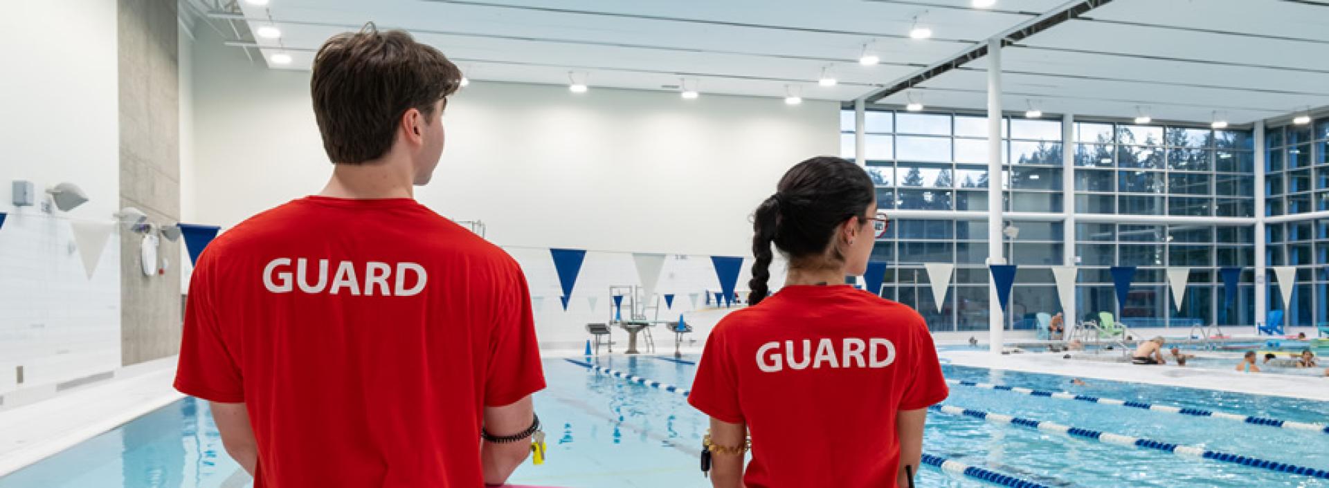 Two lifeguards on the pool deck