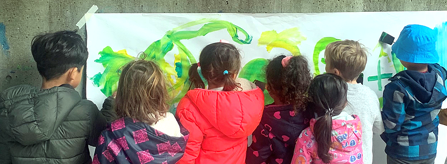 Children at Delbrook Preschool painting outside