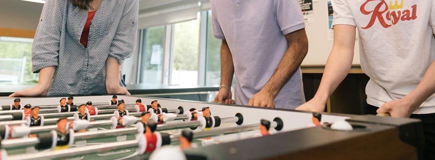 youth playing foosball