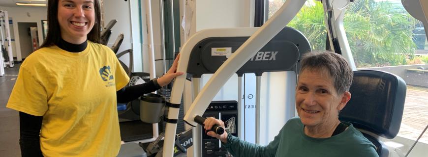 Volunteer assists in fitness centre