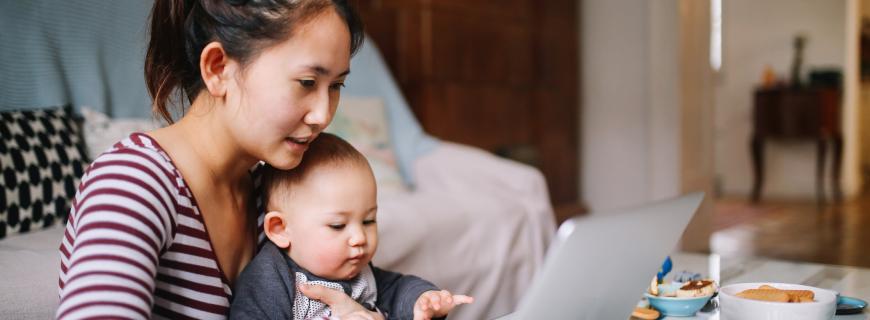 Woman and child sitting at laptop computer