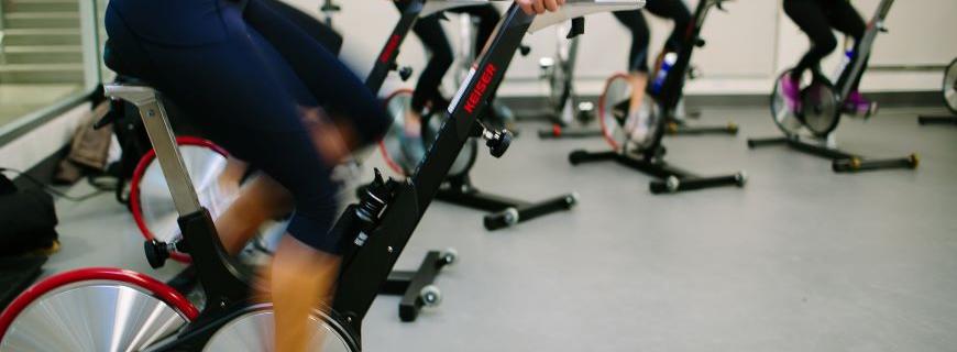 A group of women participate in a spin class