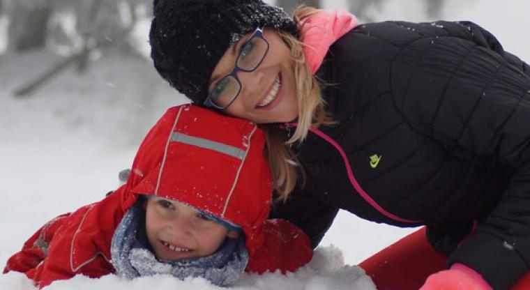 Mother and child playing in the snow