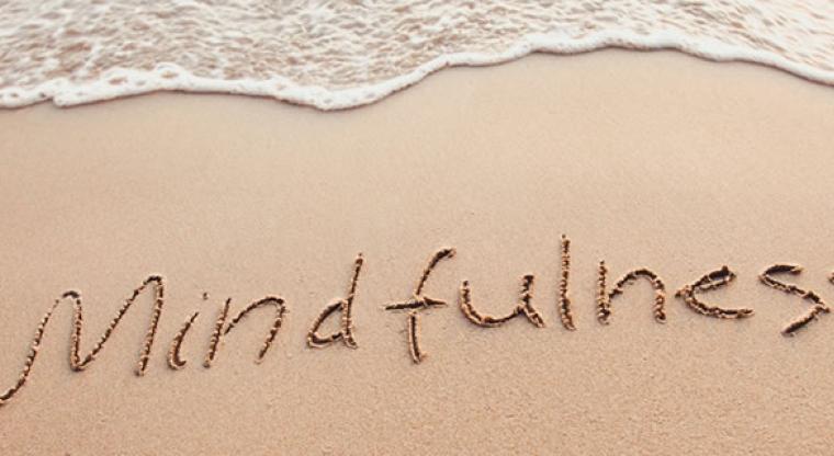 mindfulness written in the sand