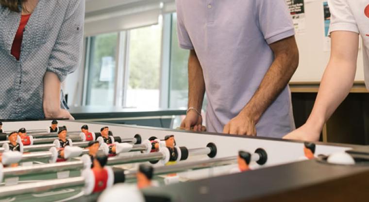 youth playing foosball
