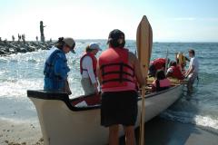 People embarking a canoe