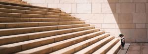 Child standing at the bottom of a flight of stairs